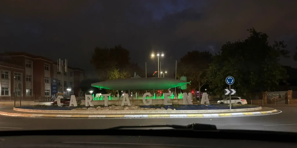 Rotonda del submarino en Cartagena iluminada de verde durante el Día Mundial de la Meningitis 2025, símbolo de esperanza y solidaridad.